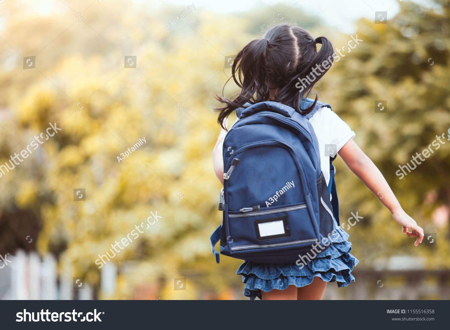 Back to school. Cute asian child girl with backpack running and going to school with fun #1155516358