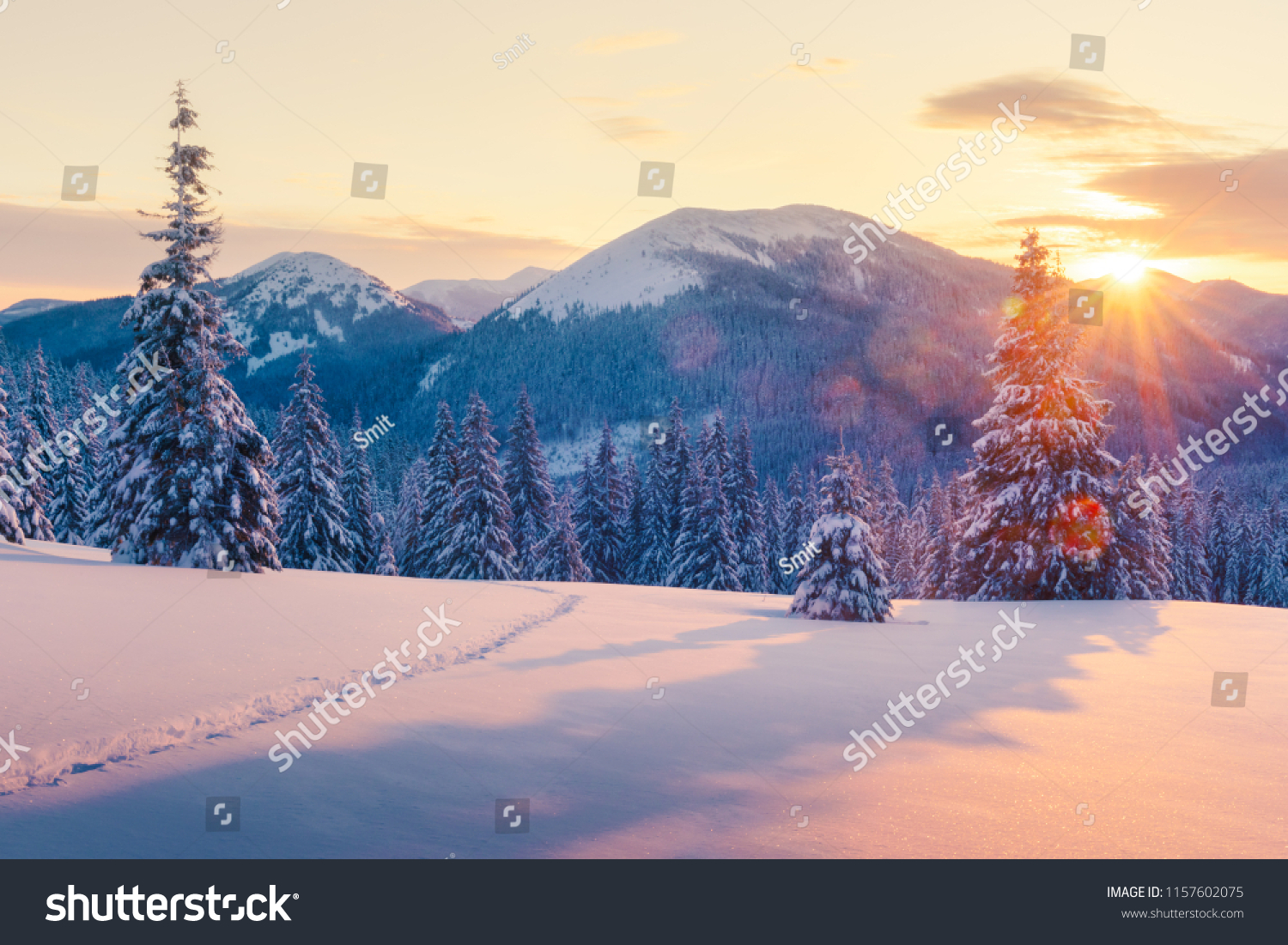 Fantastic orange winter landscape in snowy mountains glowing by sunlight. Dramatic wintry scene with snowy trees. Christmas holiday concept. Carpathians mountain, Ukraine, Europe #1157602075