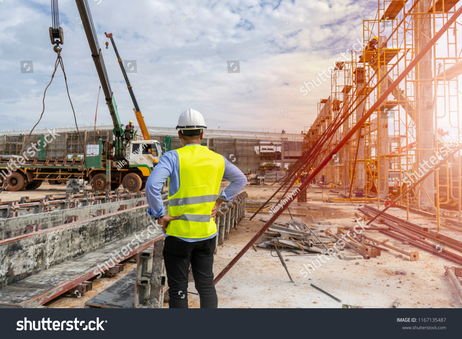 Civil Engineer supervised the construction of a tower crane and pile of concrete on construction sites in operation.
 #1167135487