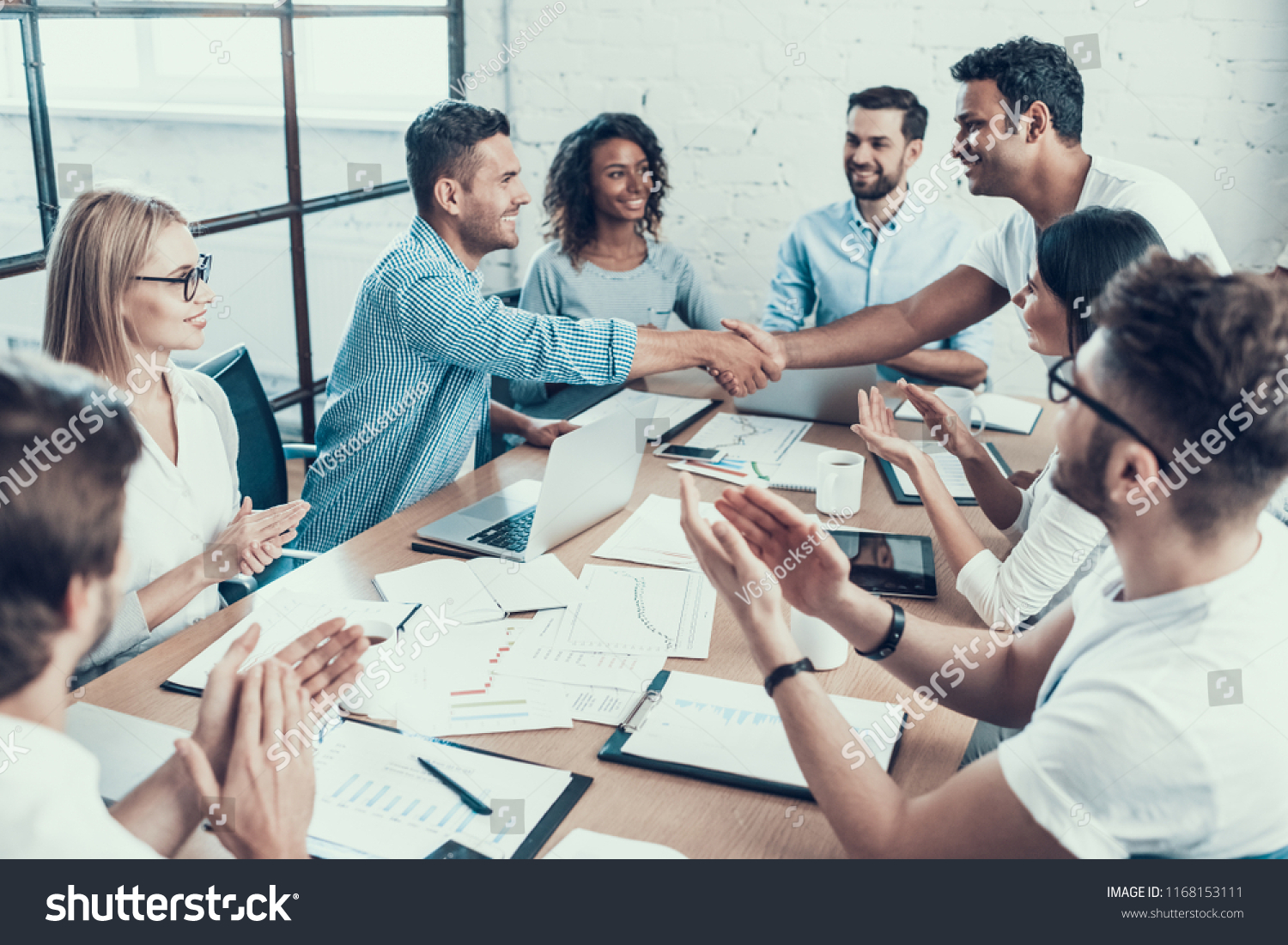 Successful Business Team Congratulating Colleague. Group of Young Happy Collegues Celebrating in Modern Office. Creative Successful Team at Work. Teamwork Concept. Corporate Lifestyle #1168153111