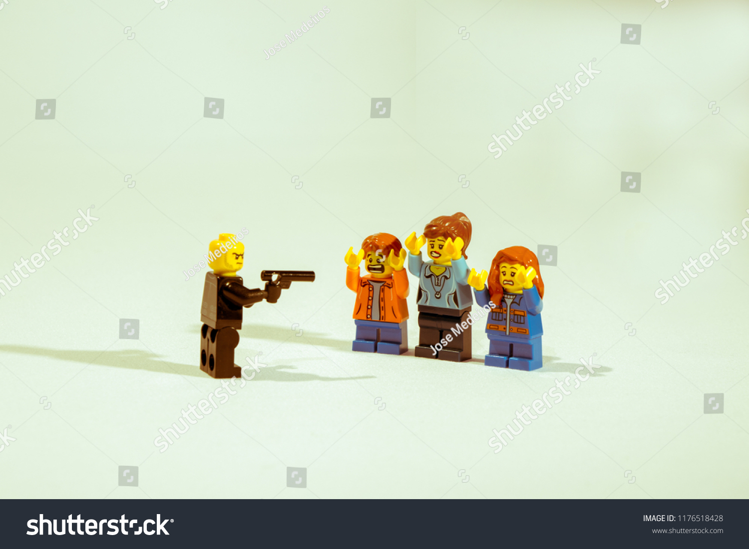 Georgia, USA - Sep 07, 2018: People or Family being mugged or robbery concept. Mini figures mugging up or arresting. Lego is a popular brand of mini figures. Lego Company is based in Denmark. #1176518428
