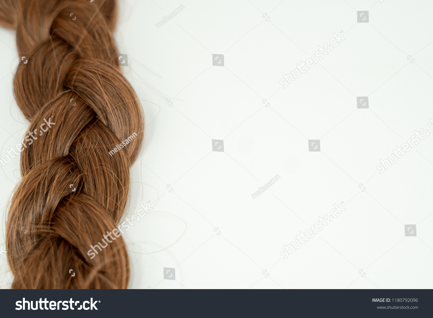 Close up of a braided hairstyle (brown brunette hair) isolated  white background. #1180792096
