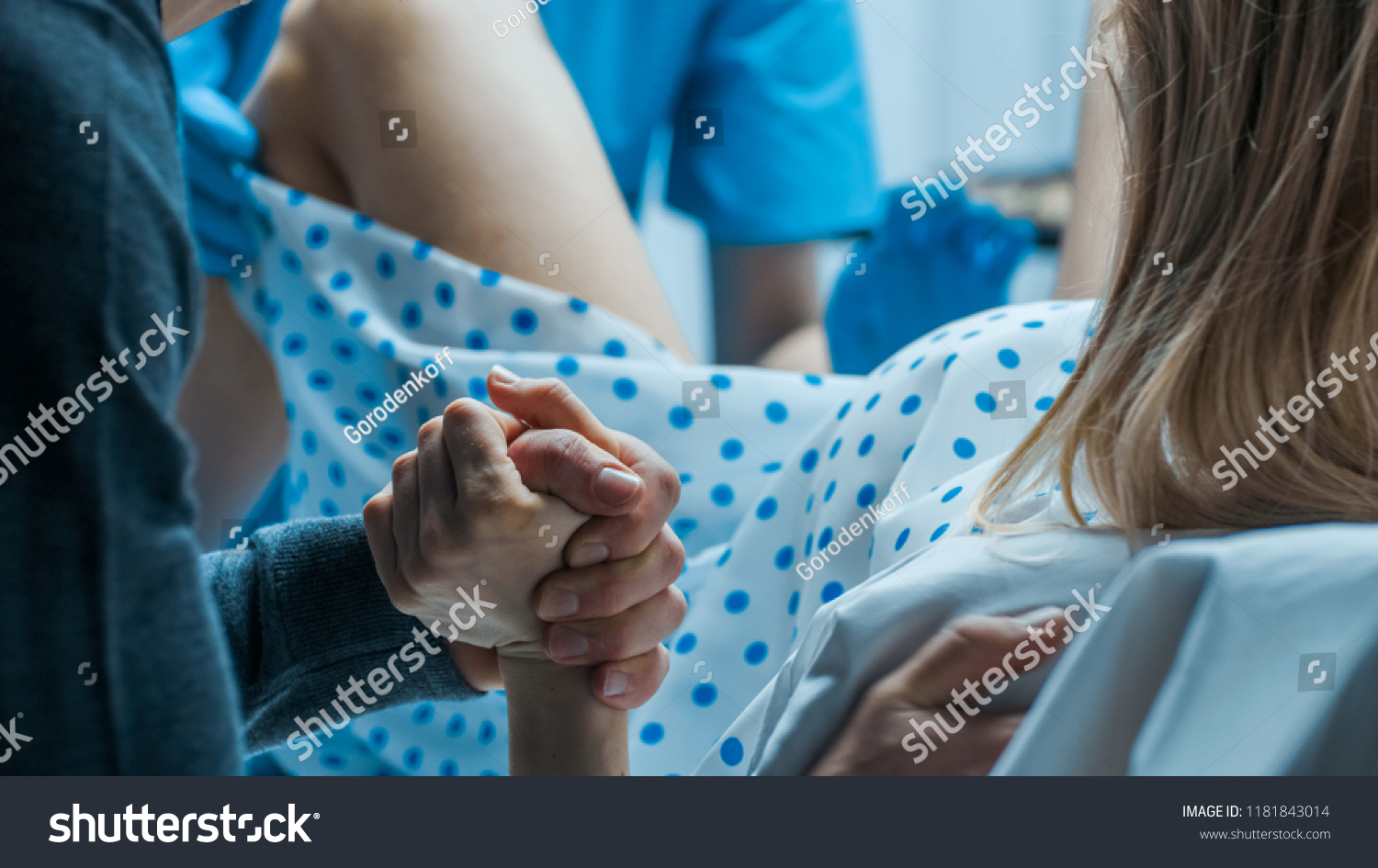 Emergency In the Hospital: Woman Giving Birth, Husband Holds Her Hand in Support, Obstetricians Assisting. Modern Delivery Ward with Professional Midwives. #1181843014