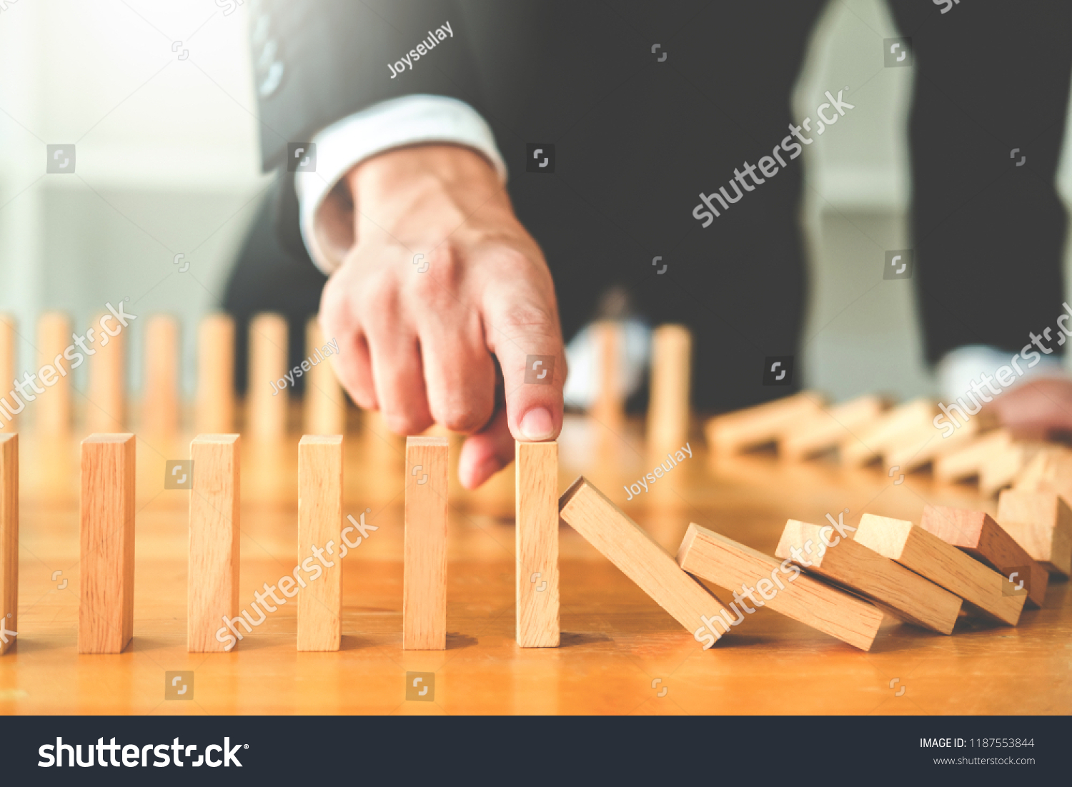 Businessman plan and strategy in business Domino Effect Leadership Management Solution concept #1187553844
