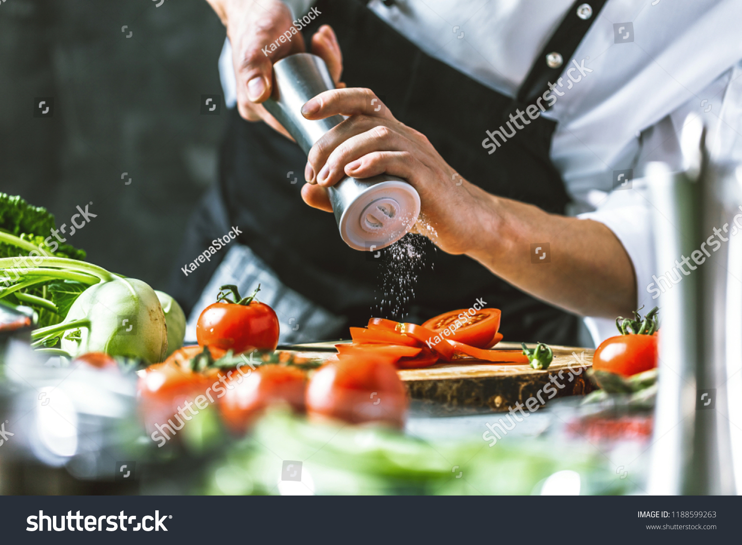 Chef cook preparing vegetables in his kitchen. #1188599263