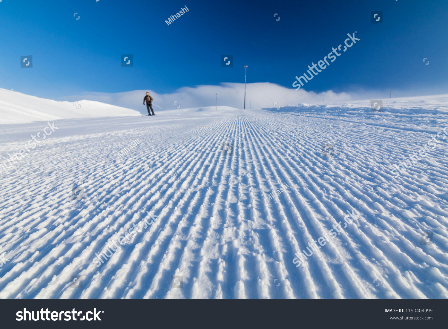 alpine skier on a fresh ski slope #1190404999