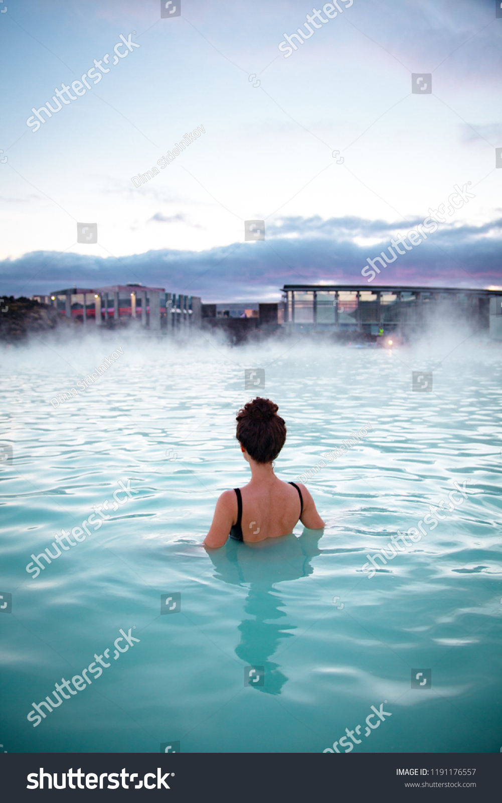 Woman relaxes and enjoys of spa in hot spring Blue Lagoon in Iceland #1191176557