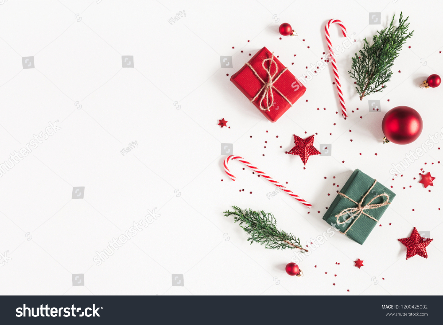 Christmas composition. Gifts, fir tree branches, red decorations on white background. Christmas, winter, new year concept. Flat lay, top view, copy space #1200425002