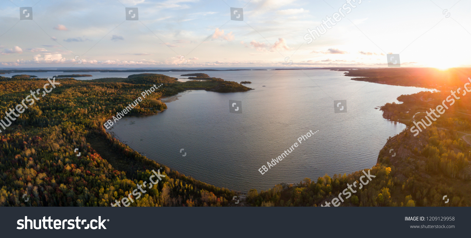 Aerial panoramic landscape view of a beautiful bay on the Great Lakes, Lake Huron, during a vibrant sunset. Located Northwest from Toronto, Ontario, Canada. #1209129958