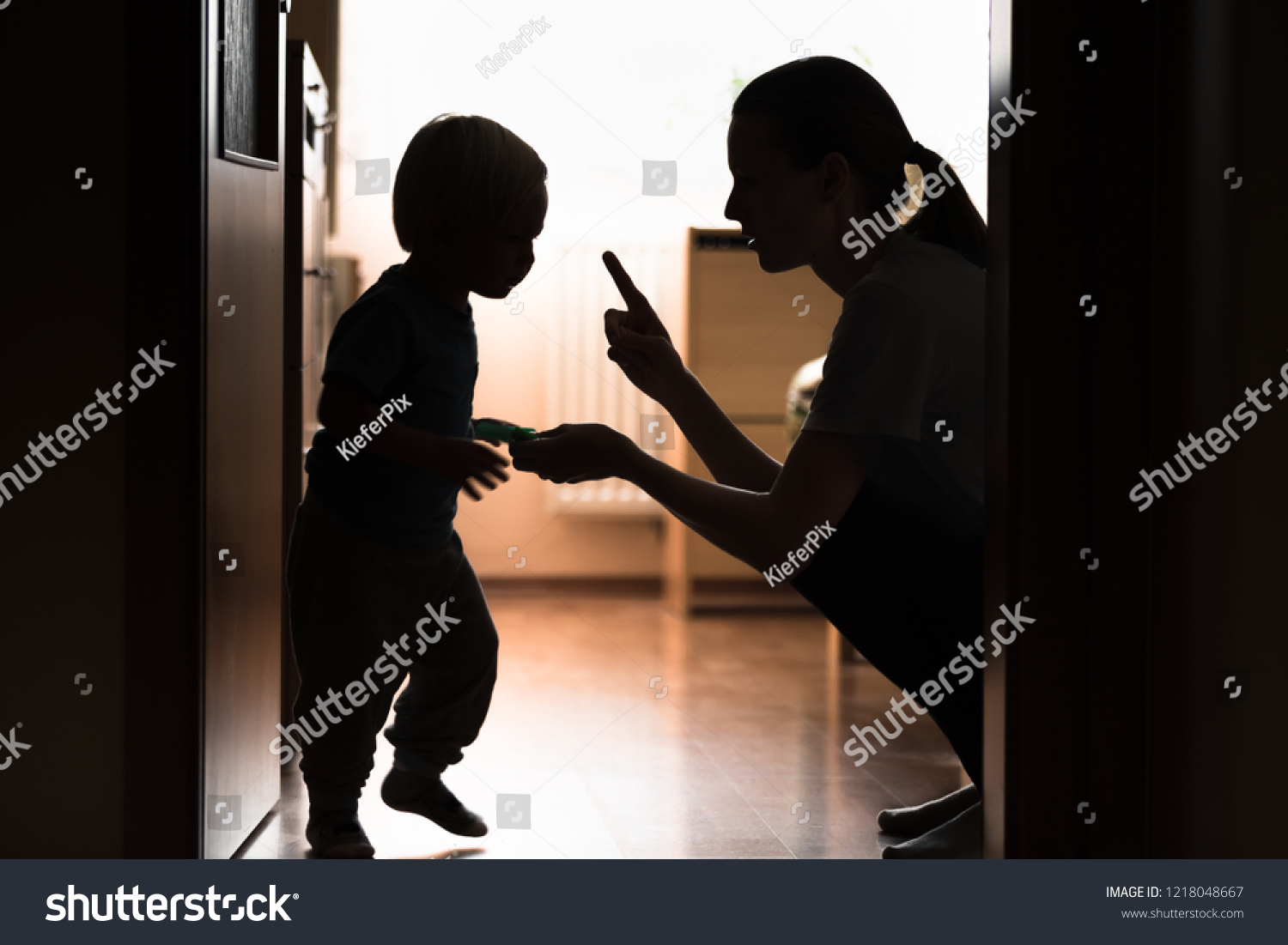 Mom disciplining her child. Teaching-parenting your kid concept.  #1218048667