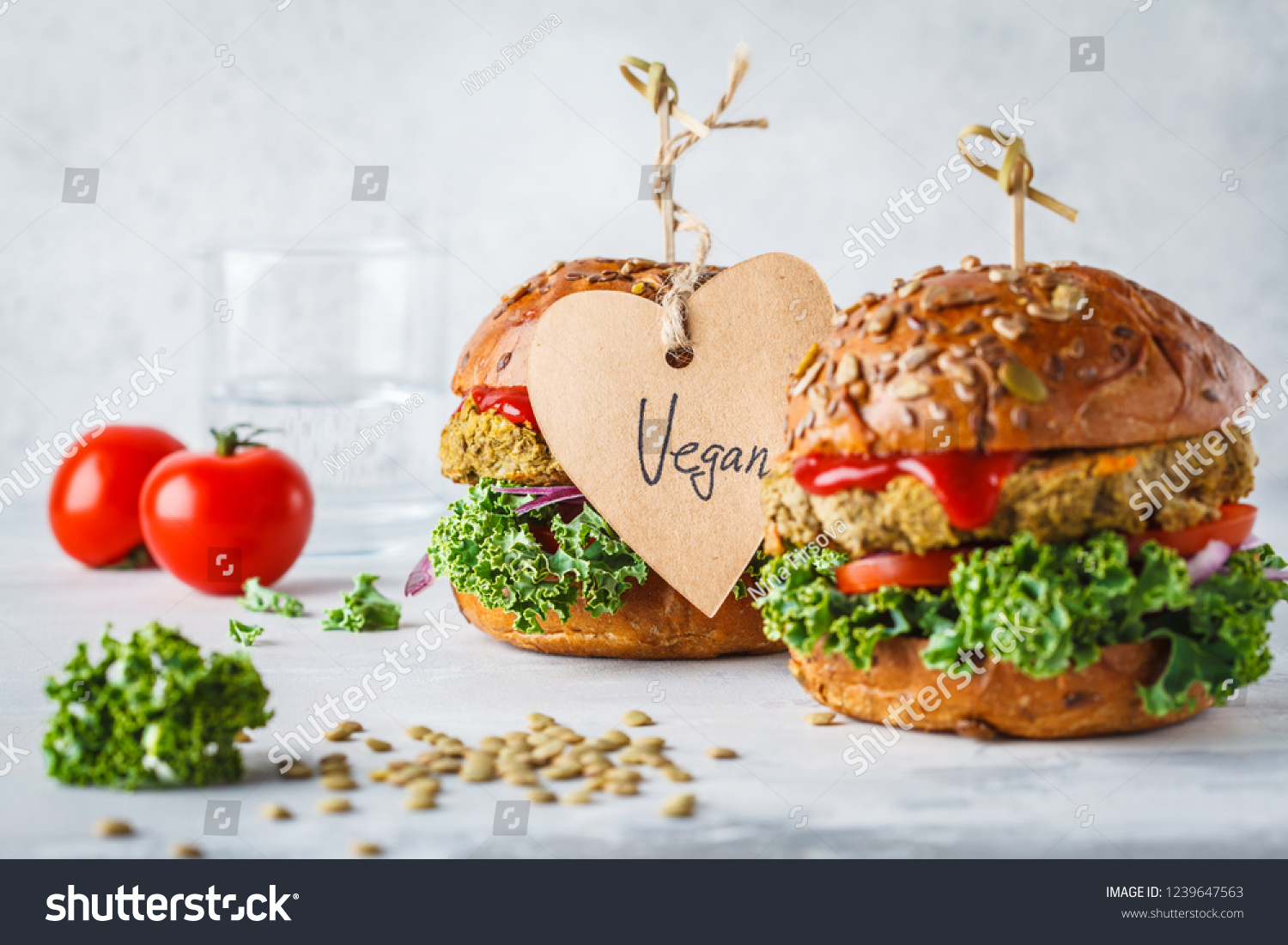 Vegan lentil burgers with kale and tomato sauce on a white background. Plant based food concept. #1239647563