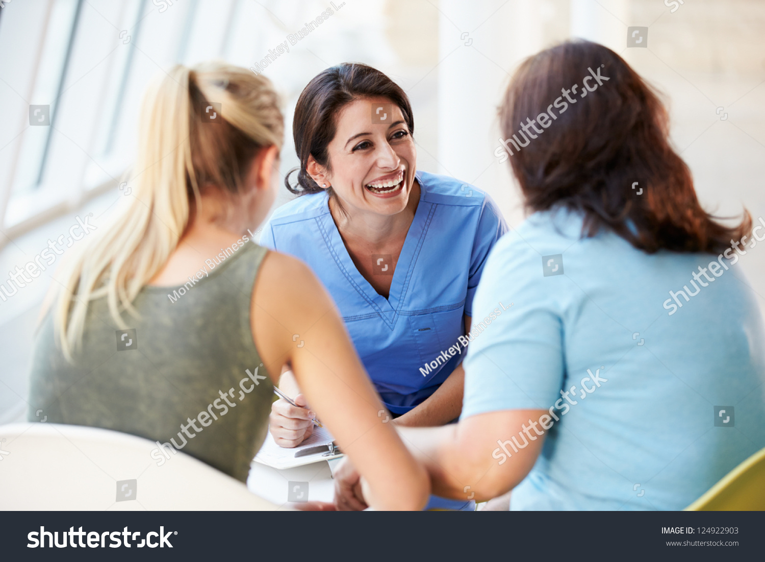 Nurse Meeting With Teenage Girl And Mother In Hospital #124922903
