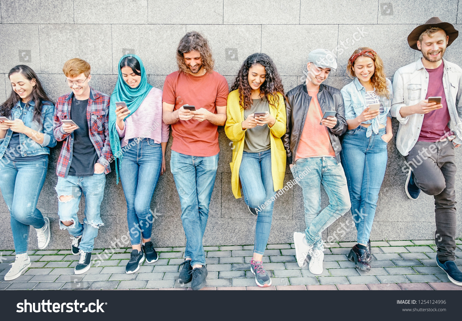 Group of fashion friends watching on their smart mobile phones - Millennial generation z addicted to new technology trends - Concept of people, tech, social media, friendship and youth lifestyle #1254124996