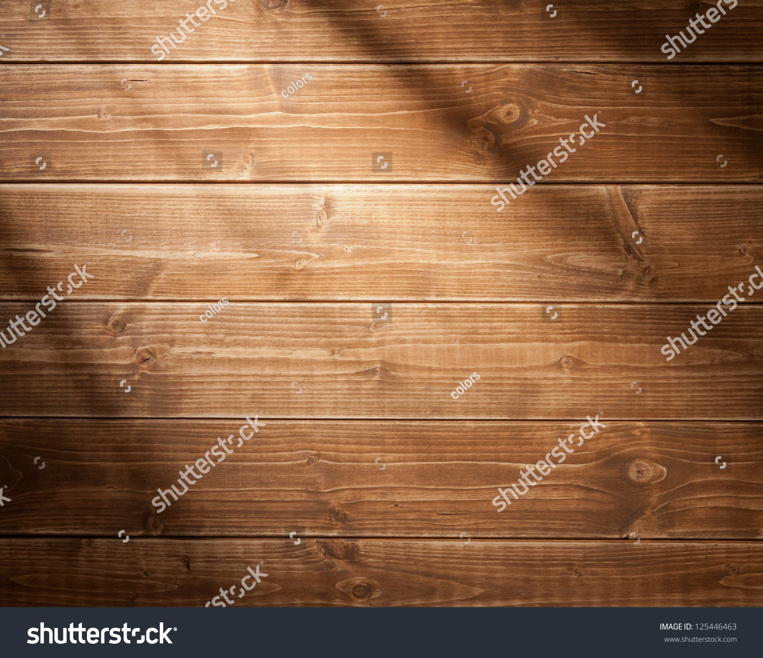 Wooden wall background in a morning light. With shadows from a window frame. #125446463