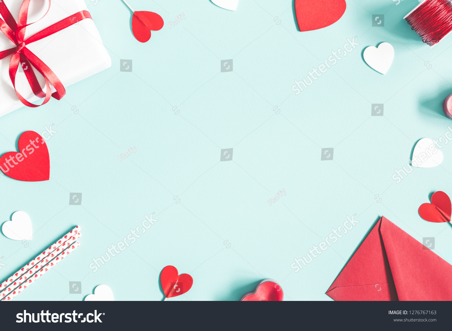 Valentine's Day background. Gifts, candle, confetti, envelope on pastel blue background. Valentines day concept. Flat lay, top view, copy space #1276767163