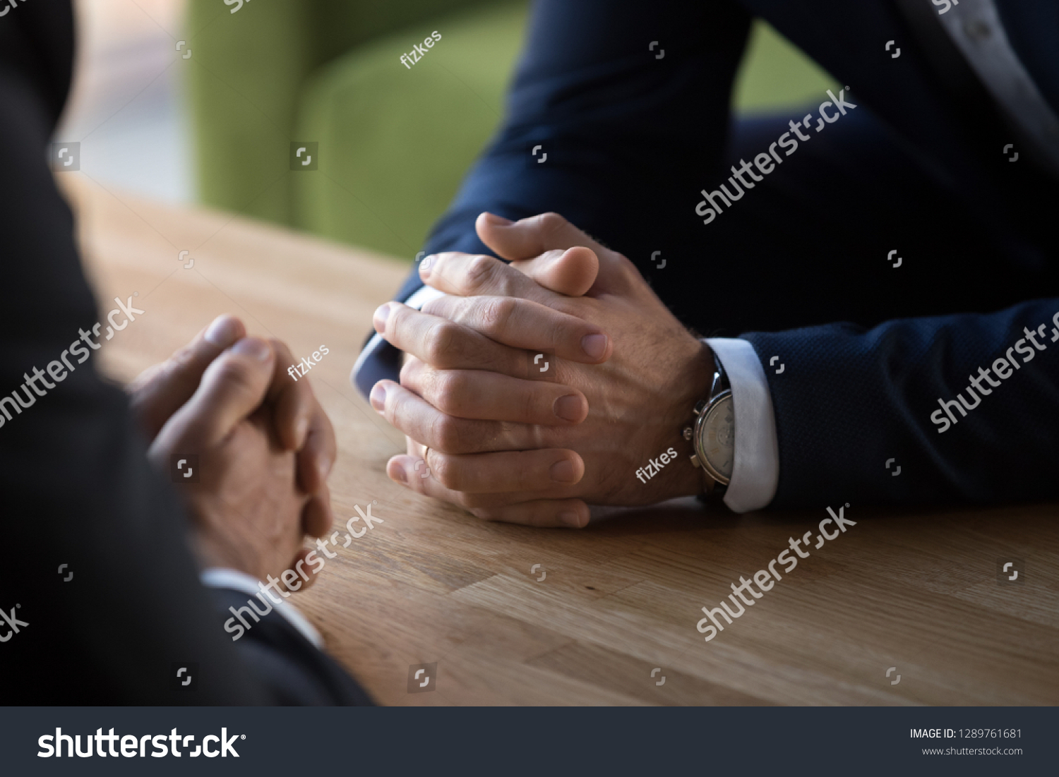 Clasped male hands of two businessmen negotiate at table, hr recruiter making hiring decision at difficult job interview, opponents dialogue debate, business confrontation challenge concept, close up #1289761681