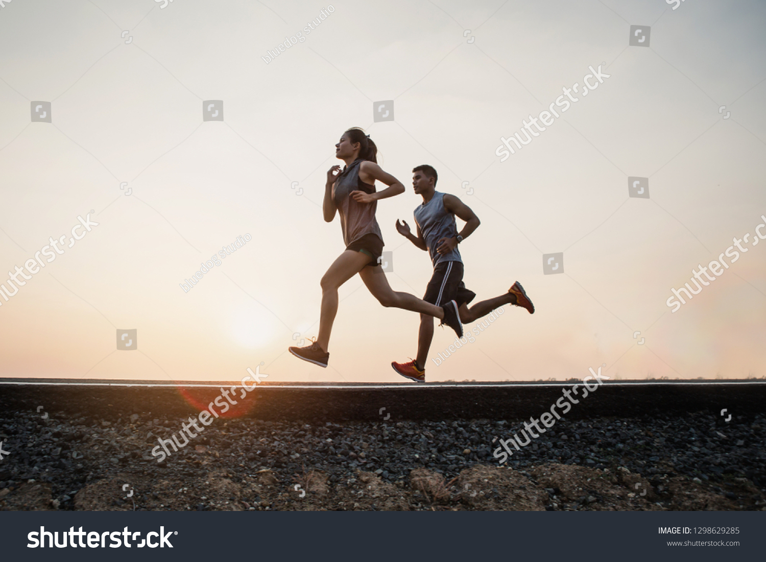 Young couple running on the street be running for exercise. fitness, sport, people, exercising ,running and lifestyle concept . #1298629285