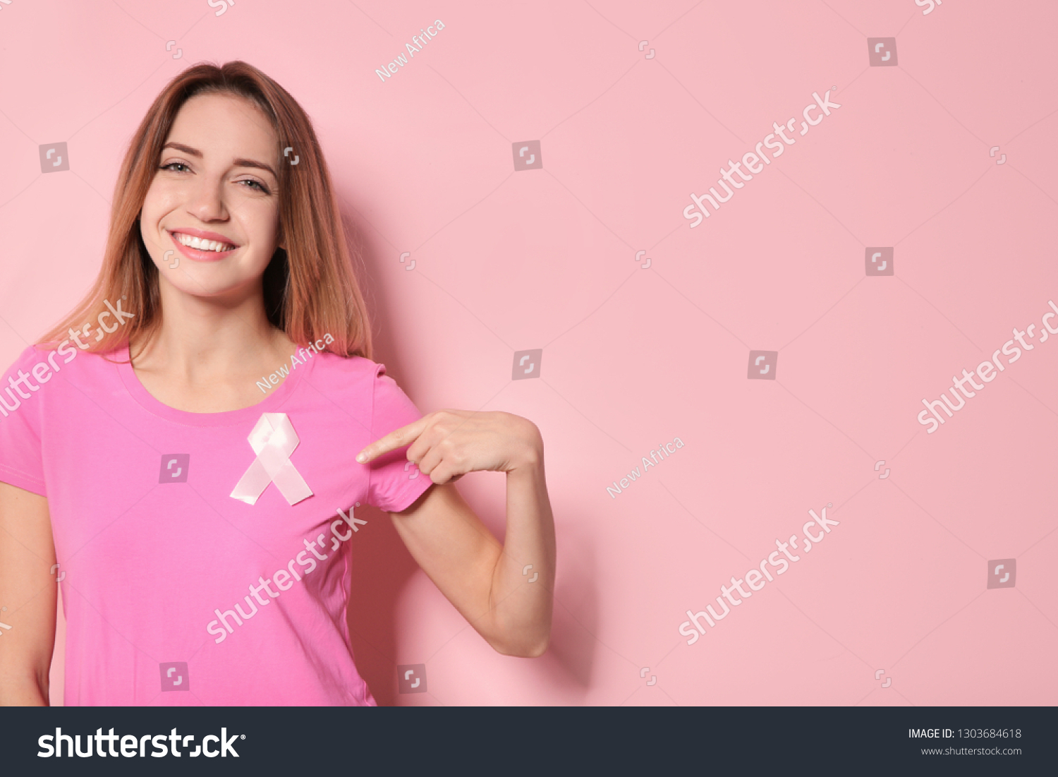 Woman with silk ribbon and space for text on color background. Breast cancer awareness concept #1303684618