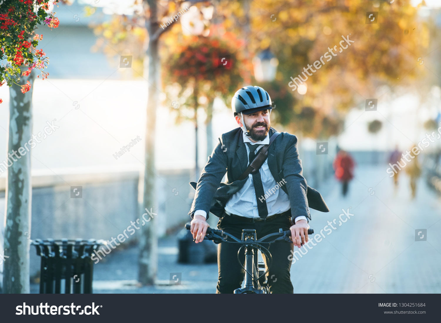 Hipster businessman commuter with electric bicycle traveling home from work in city. #1304251684