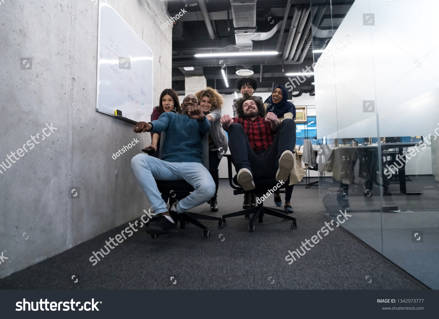 multiethnics startup business team of software developers having fun while racing on office chairs,excited diverse employees laughing enjoying funny activity at work break, #1342973777