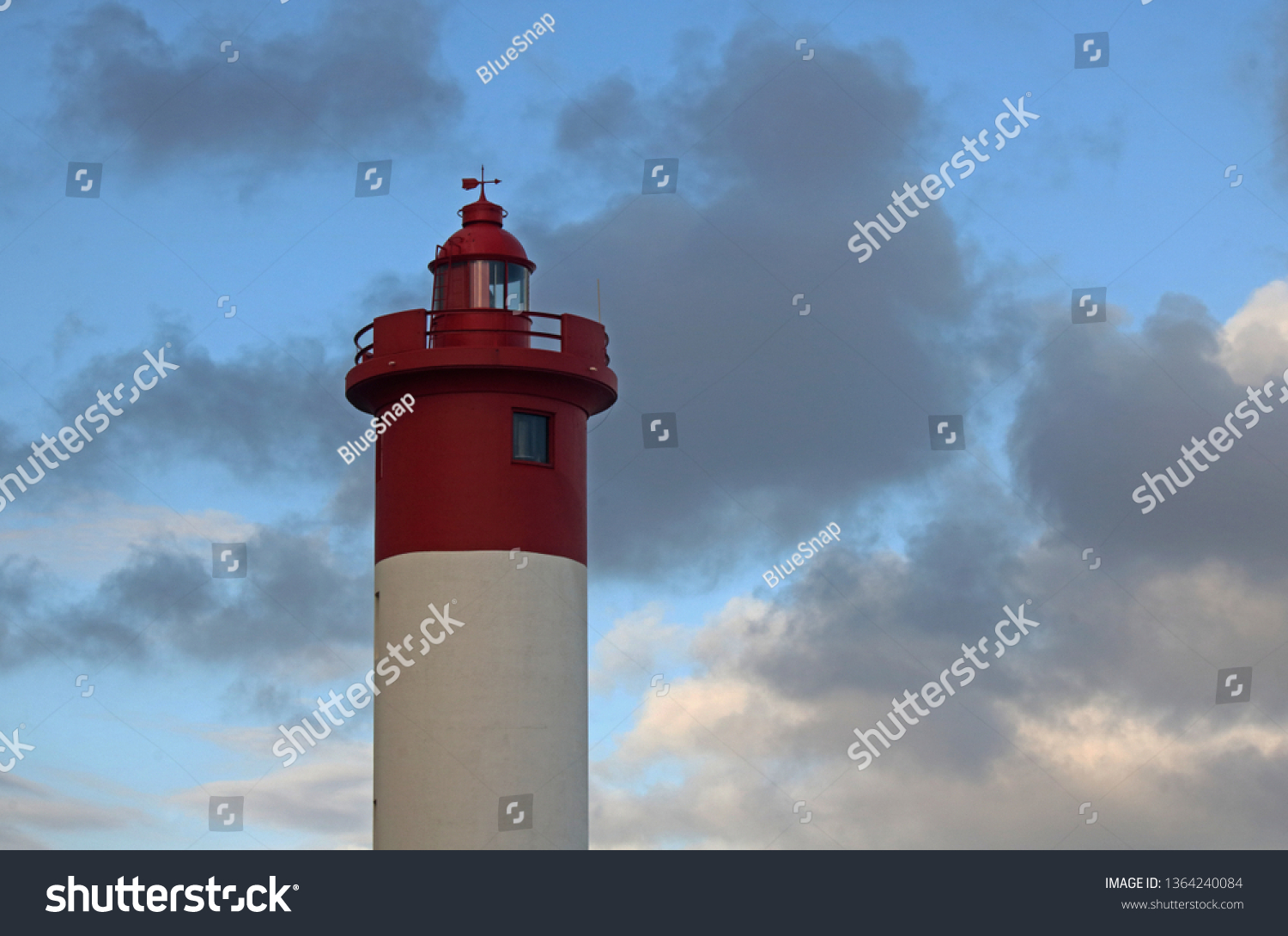 LIGHTHOUSE AT UMHLANGA ROCKS AGAINST THE SKY AND CLOUDS #1364240084