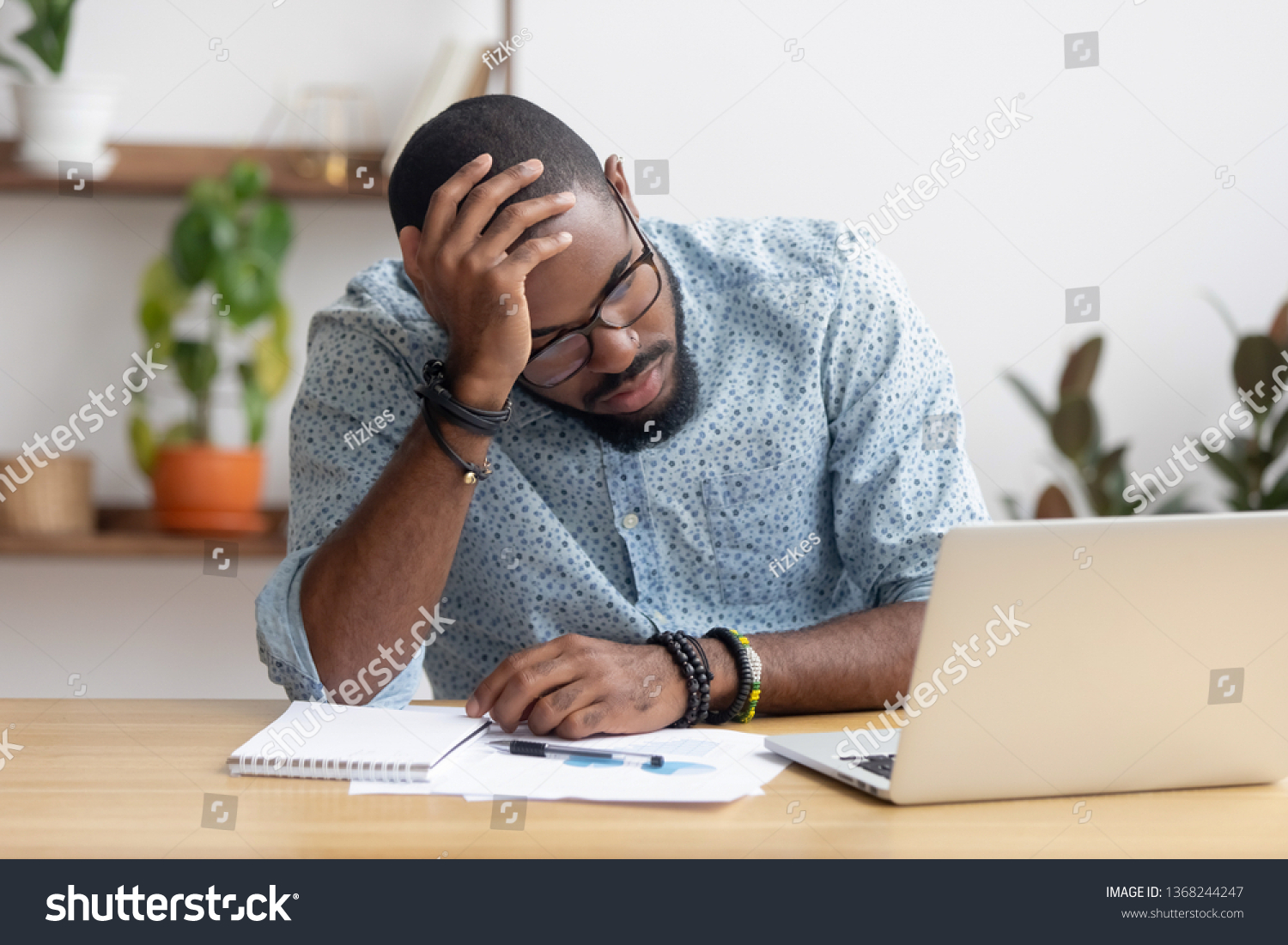 Tired depressed bored african businessman frustrated by business failure bankruptcy looking at laptop feel exhausted having headache, upset stressed black office worker worried about problem at work #1368244247