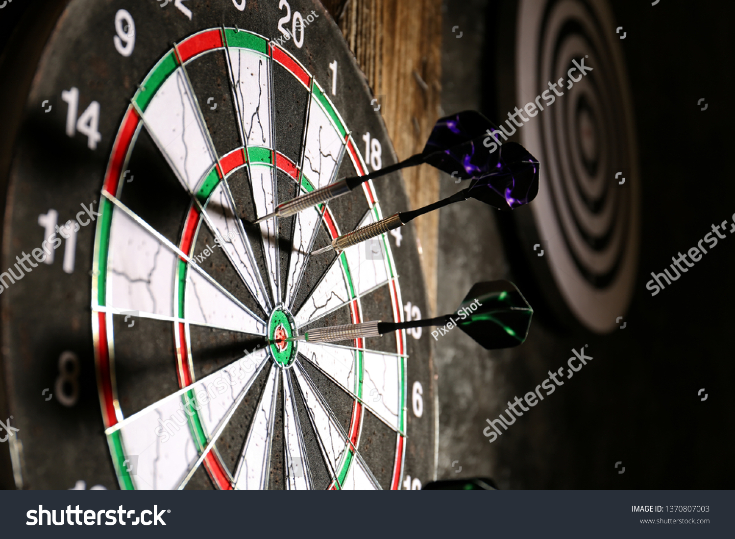 Dartboard with darts, closeup #1370807003