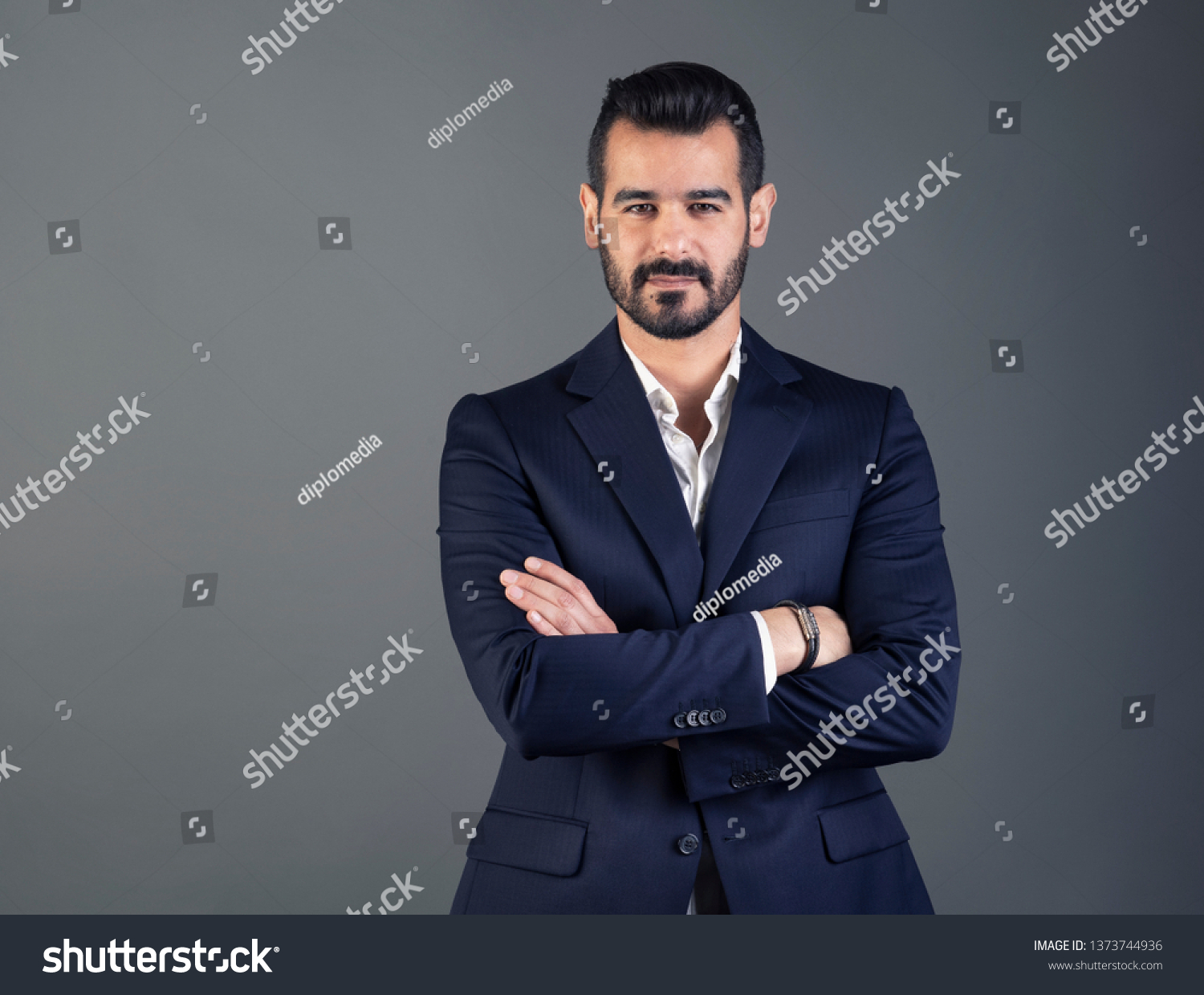 Portrait of young and handsome business man with arms crossed  #1373744936