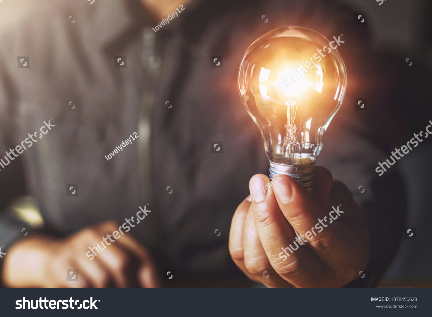 hand holding light bulb. idea concept with innovation and inspiration #1378450628