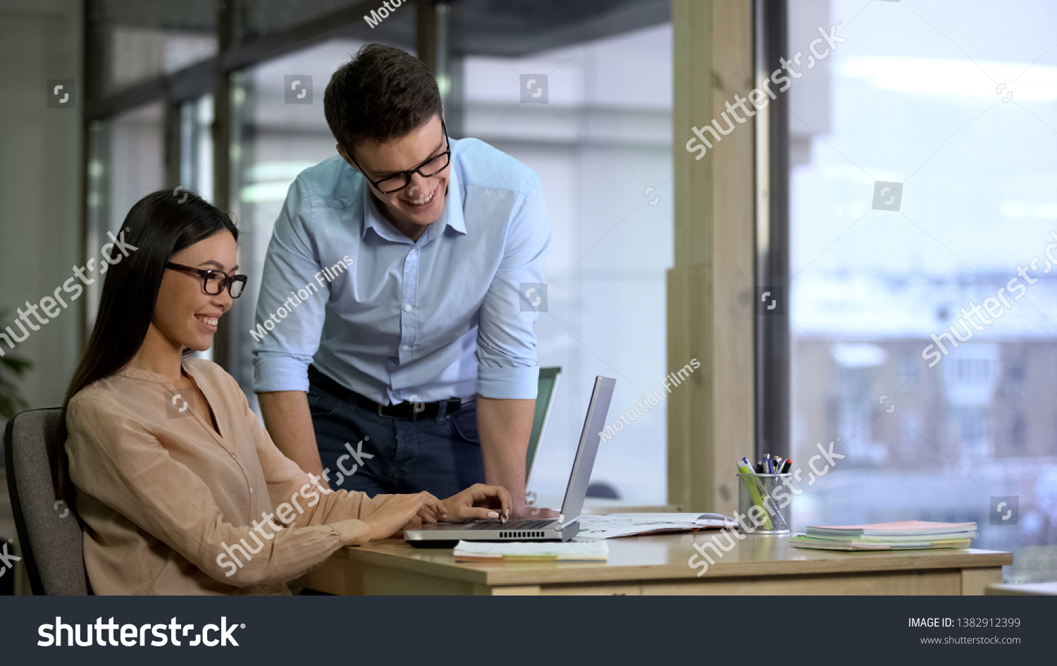 Multiracial smiling colleagues searching for information in internet, workplace #1382912399
