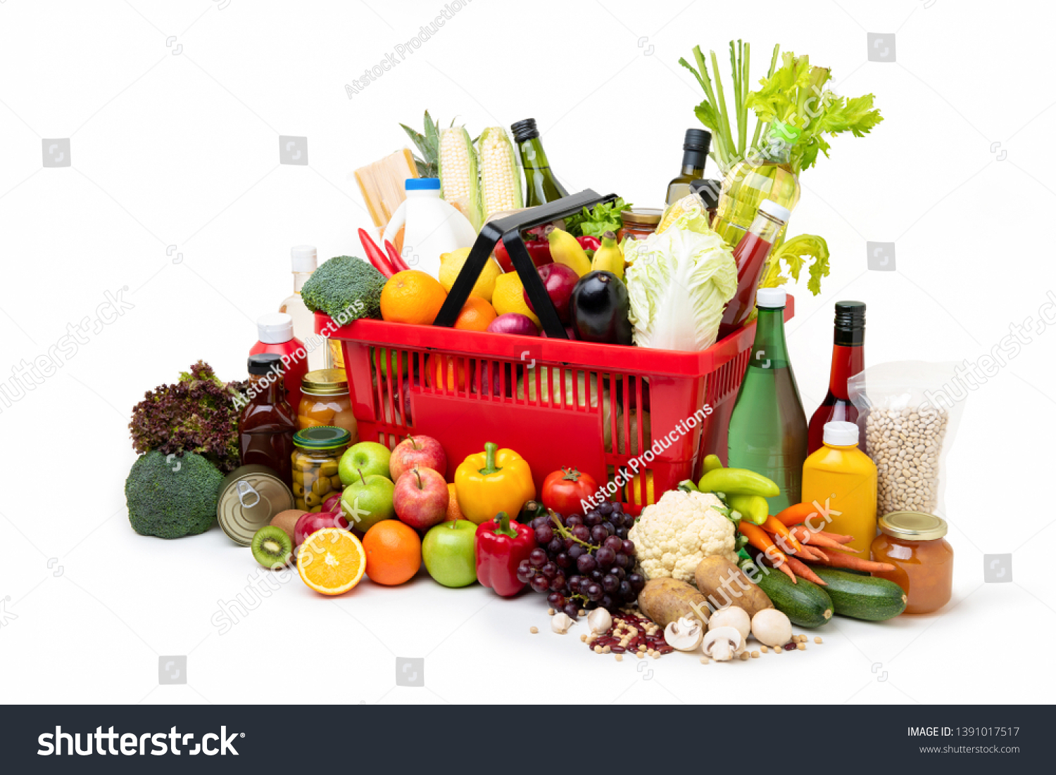 Red supermarket shopping basket full of  fresh organic colorful foods and groceries with assorted ingredients on white background #1391017517