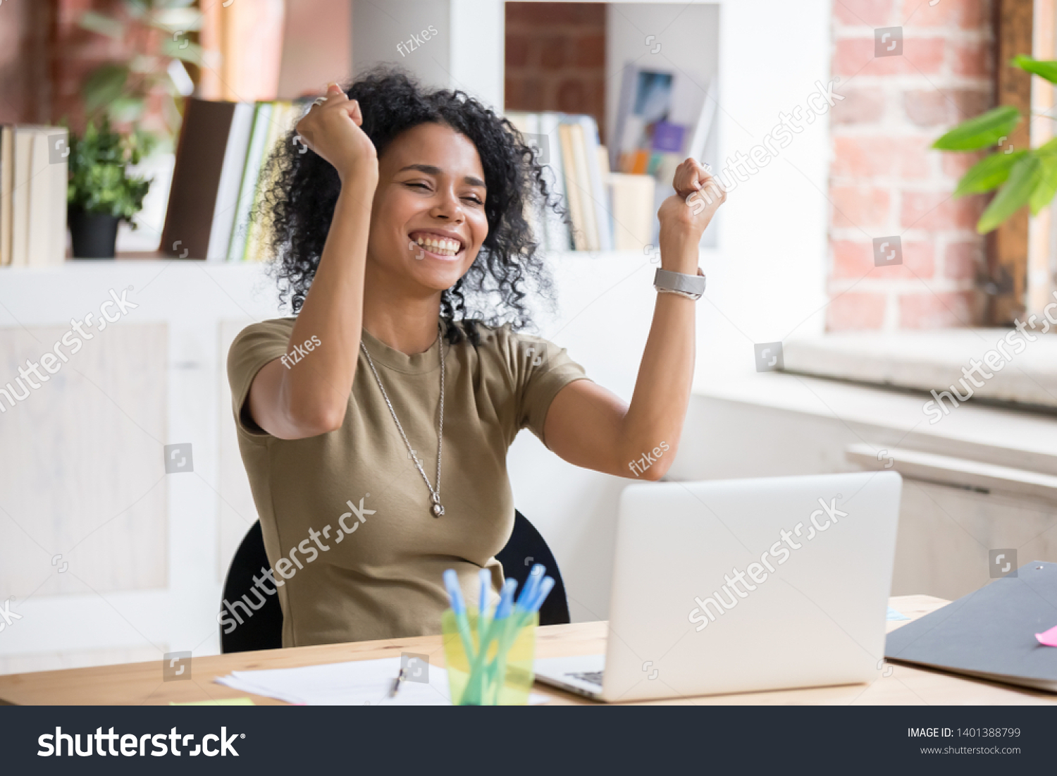 Excited african American woman sit at desk feel euphoric win online lottery, happy black woman overjoyed get mail at laptop being promoted at work, biracial girl amazed read good news at computer #1401388799