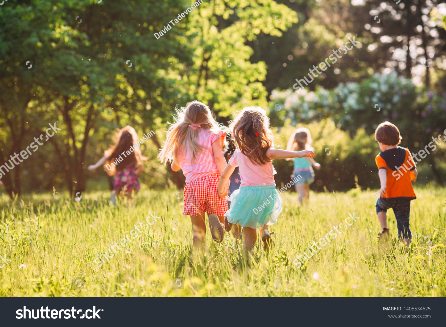 Large group of kids, friends boys and girls running in the park on sunny summer day in casual clothes  #1405534625