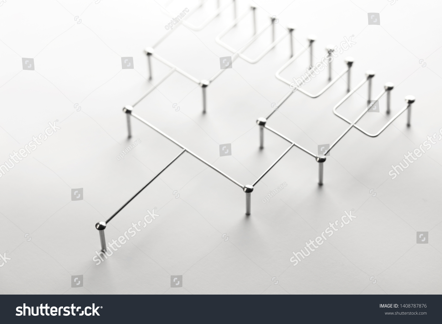 Hierarchy, command chain, company / organization structure or layer concept image. Tournament bracket structure made from chrome wires and nails on white. Shallow depth of field. #1408787876
