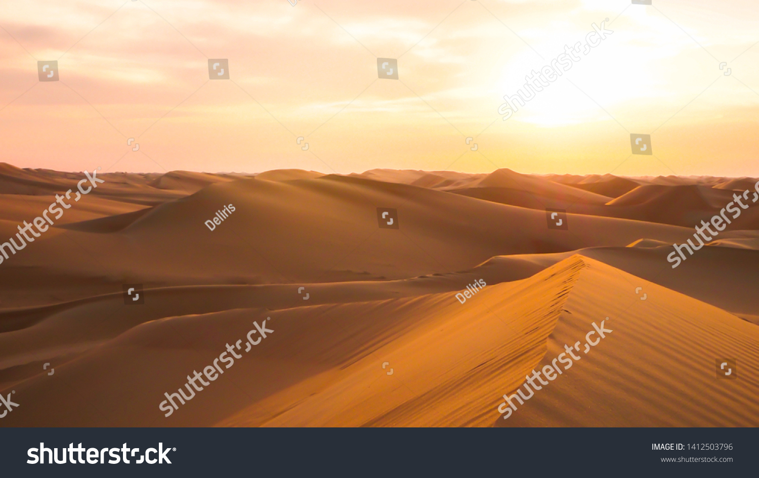 Amazing desert sunset. Beautiful Arabian desert with warm colors. Colorful contours of sand dunes at Abu Dhabi.  #1412503796