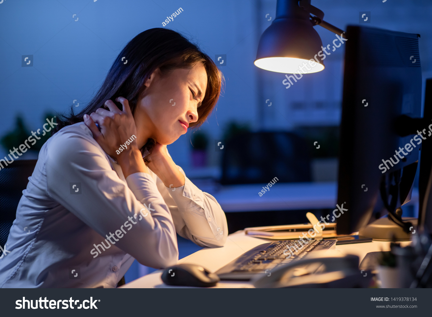asian woman overtime work and feel shoulder pain in the office #1419378134