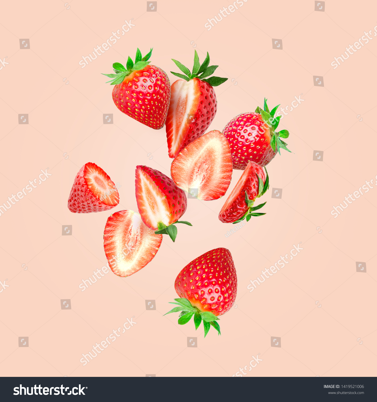 The composition of strawberries on a colored background. Cut strawberries into pieces with copy space. Fresh natural strawberry isolated. Strawberry slices flying in the air #1419521006