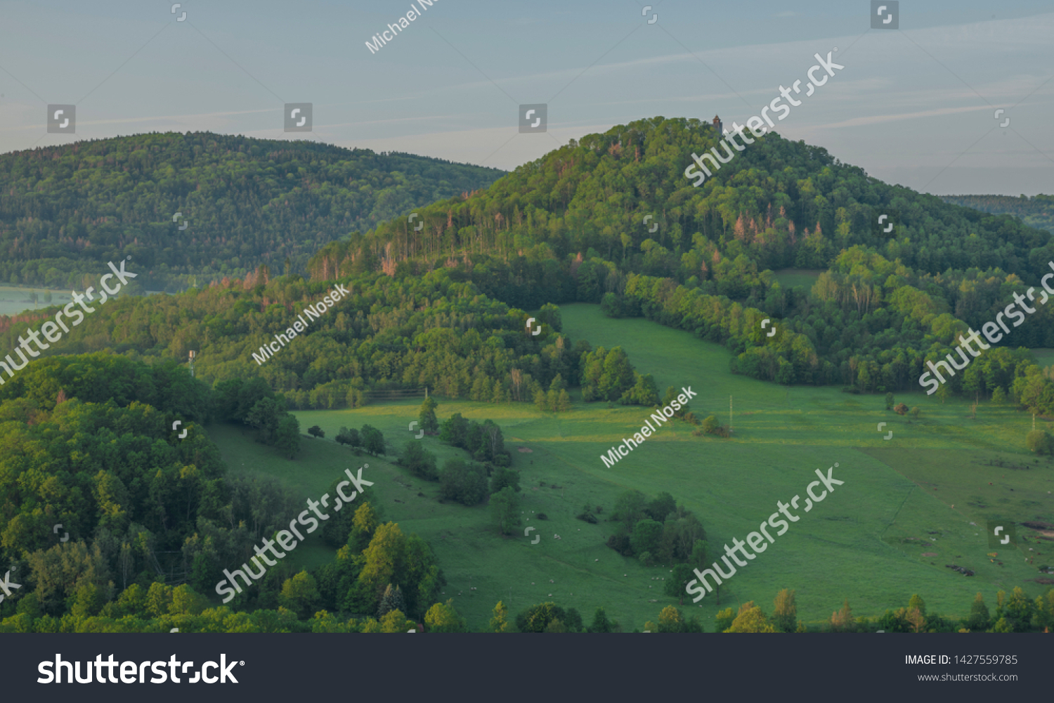 View from Jehla hill over Ceska Kamenice town in spring misty morning in national park #1427559785
