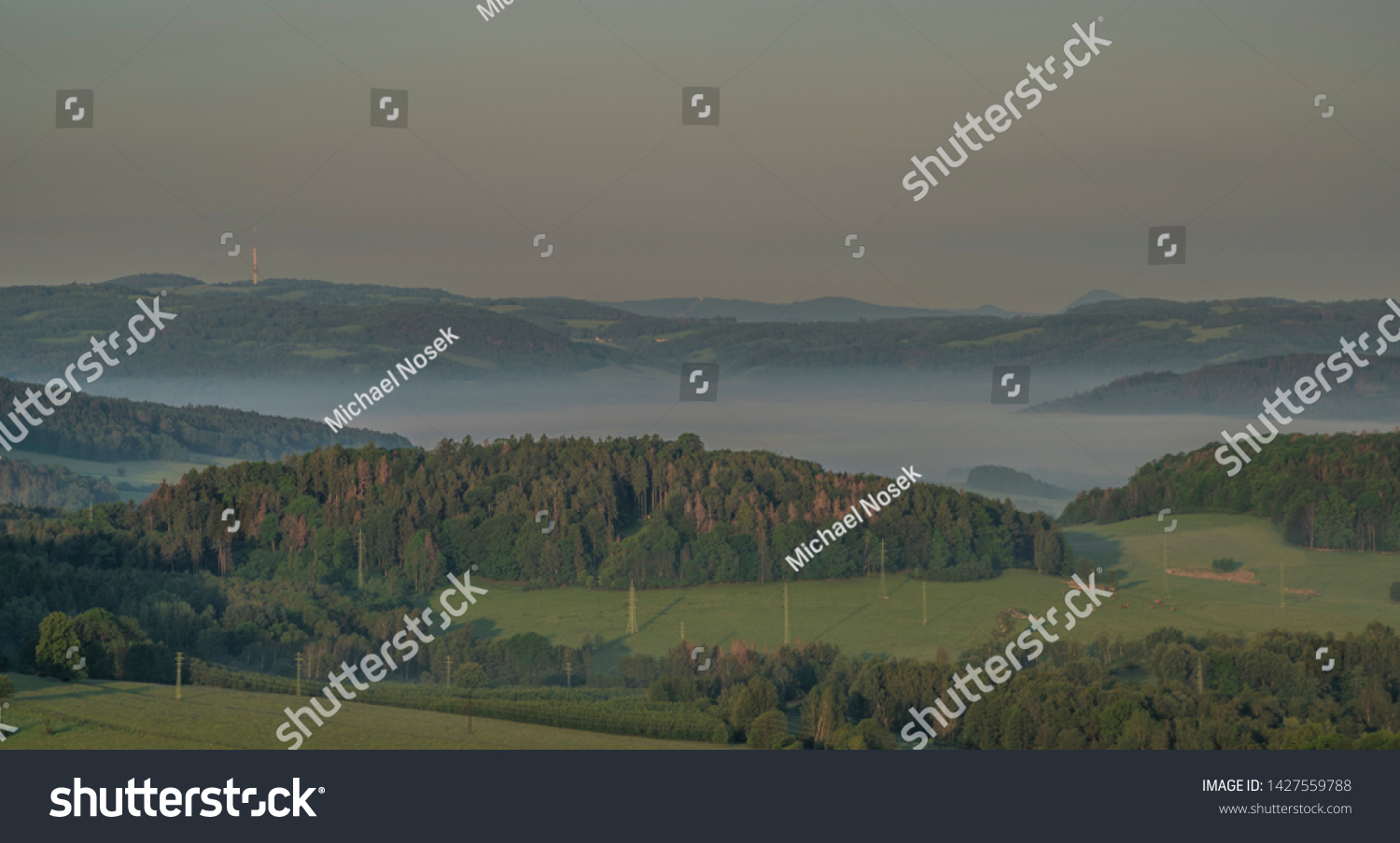 View from Jehla hill over Ceska Kamenice town in spring misty morning in national park #1427559788