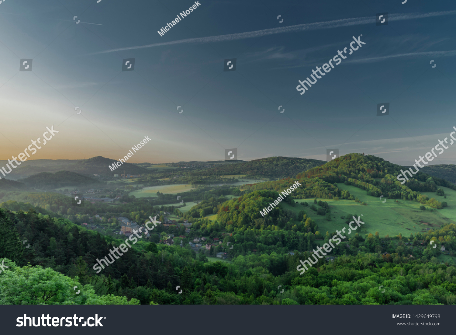 View from Jehla hill over Ceska Kamenice town in spring misty morning in national park #1429649798