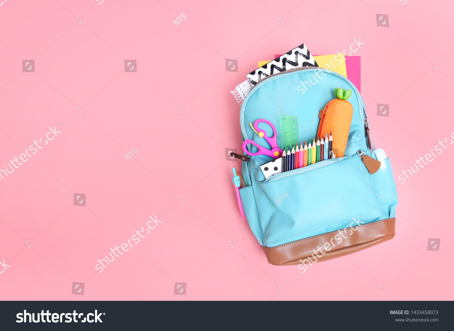 Backpack with school supplies top view on pink empty space background. #1433458073