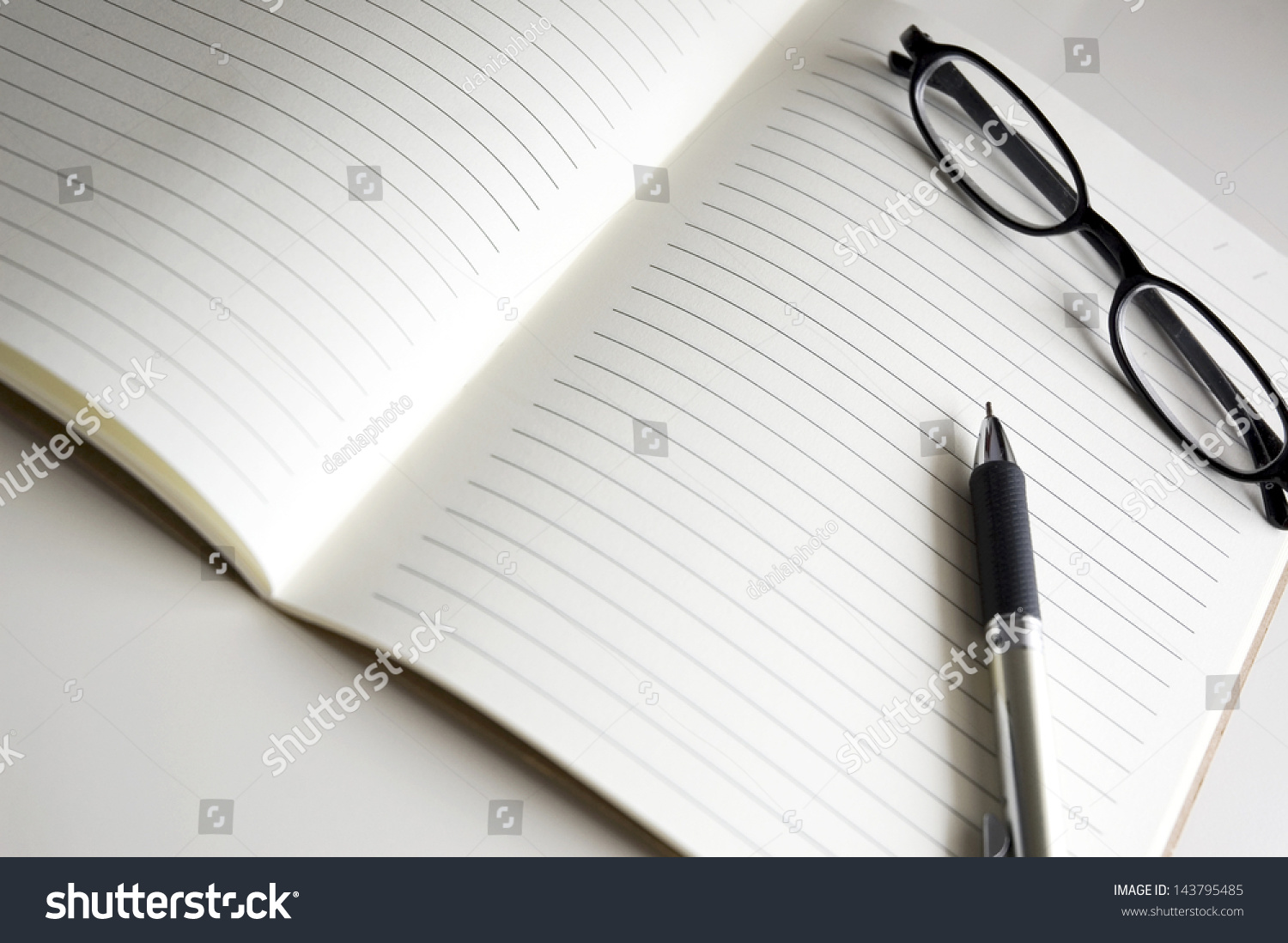 blank notebook pages with pen and glasses #143795485