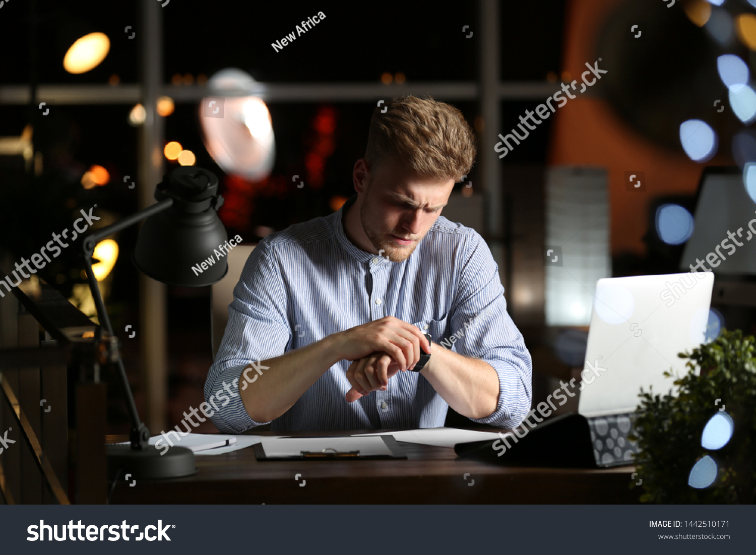 Young man working in office at night #1442510171