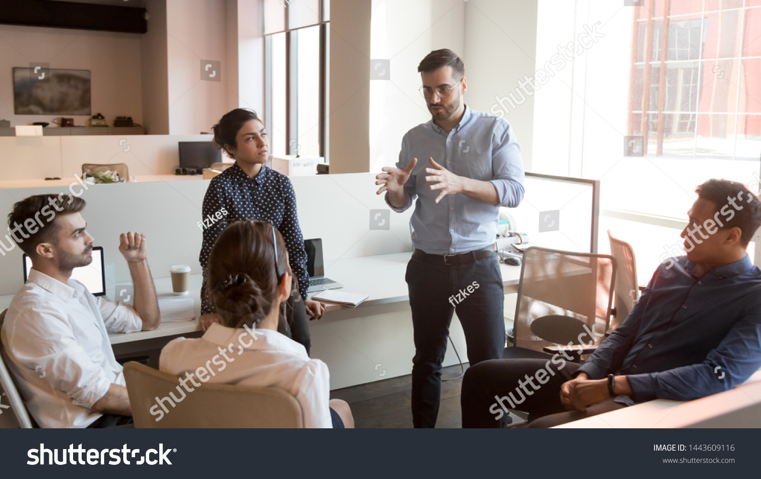 Serious business man team leader coach mentor talk to diverse business people in office explain strategy at corporate group meeting, multiethnic staff listen to boss instruct interns at briefing #1443609116