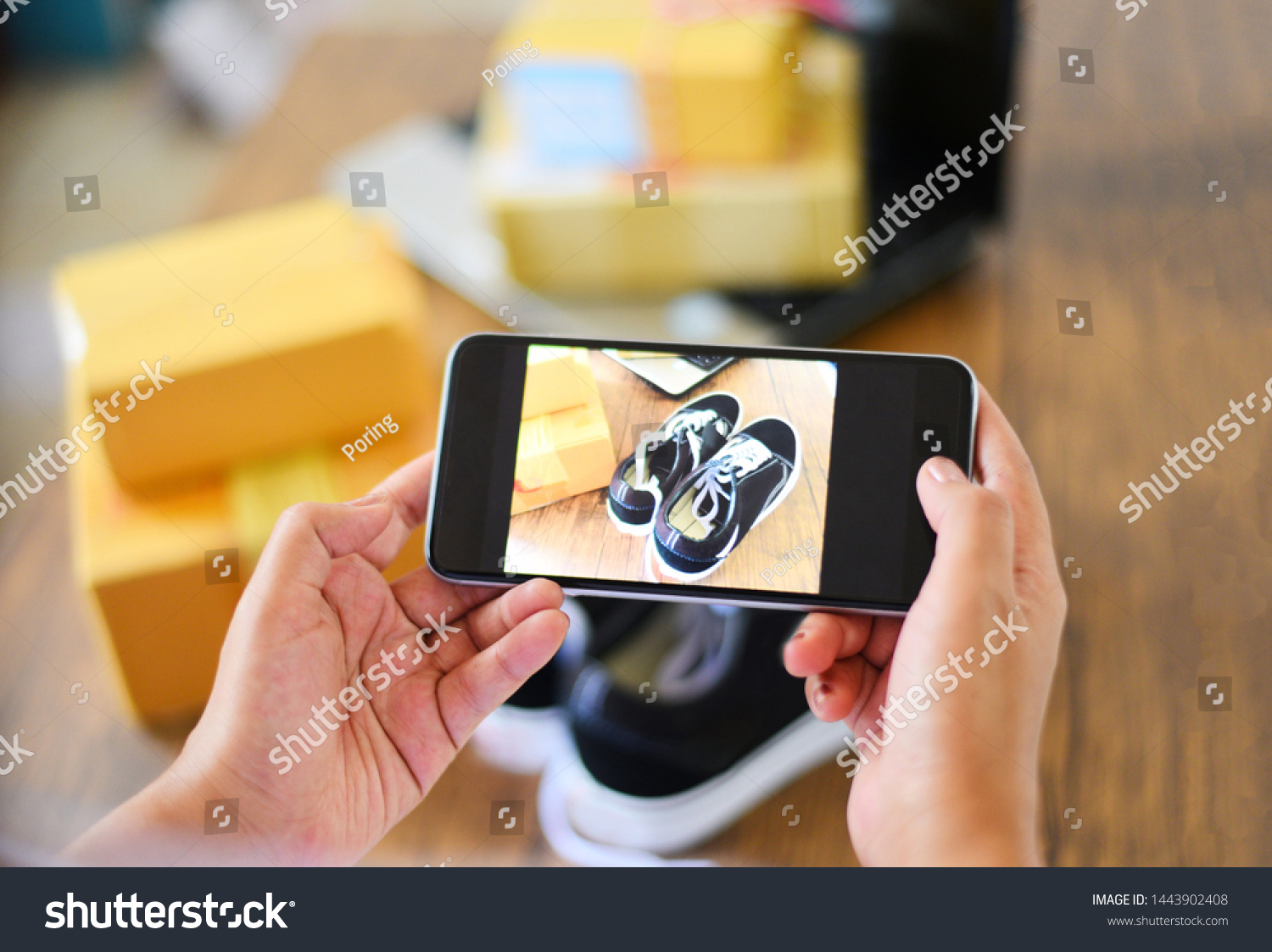 young woman taking photo sneakers with camera smartphone for post to sell online on the internet market website / selling online ecommerce shipping online shopping delivery and order concept #1443902408
