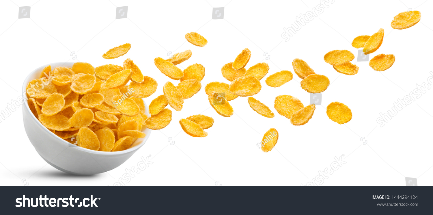 White ceramic bowl of dry uncooked corn flakes. Traditional breakfast yellow cereal in isolated porcelain plate. Falling cornflakes on white background #1444294124