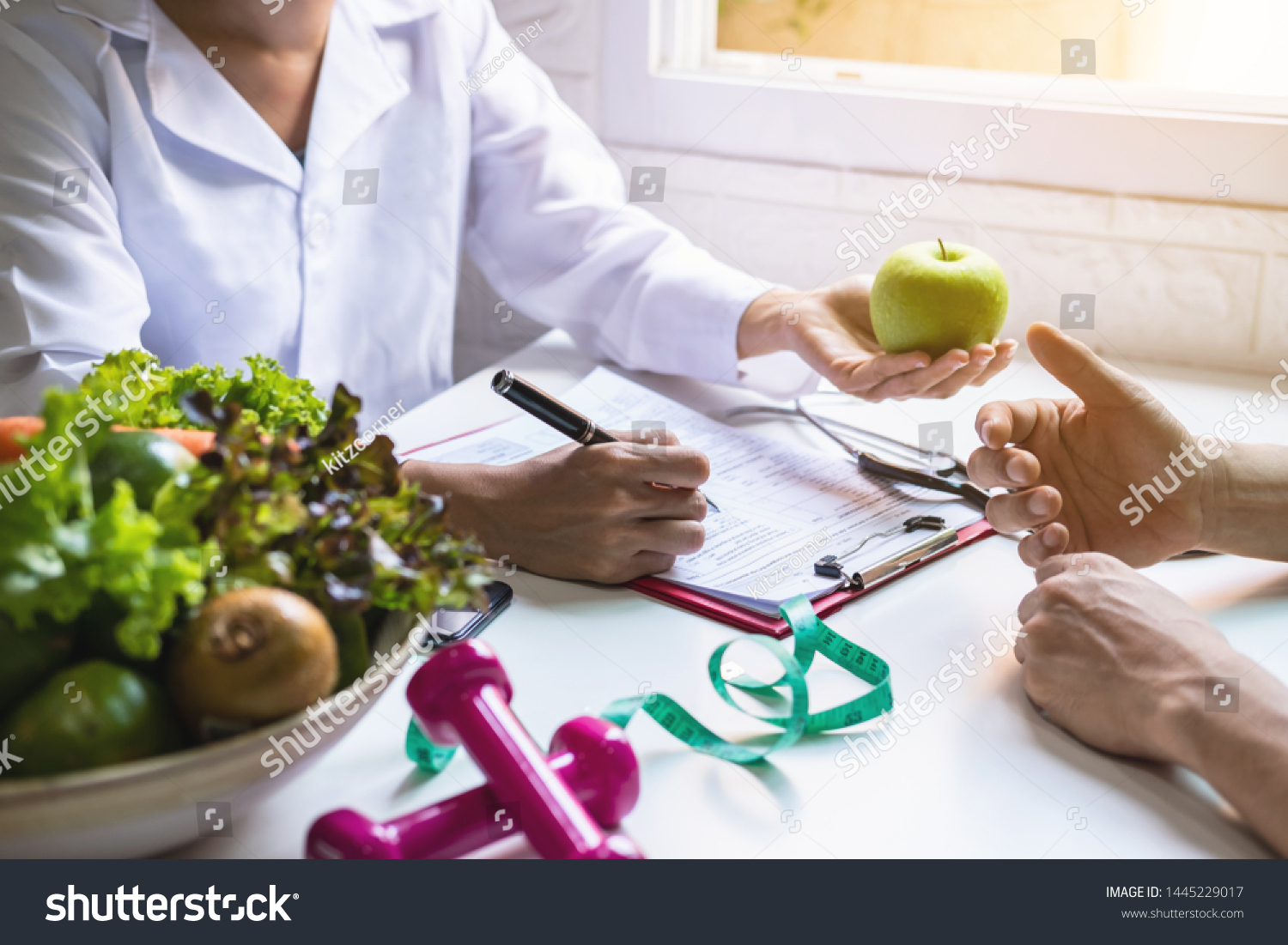 Nutritionist giving consultation to patient with healthy fruit and vegetable, Right nutrition and diet concept #1445229017