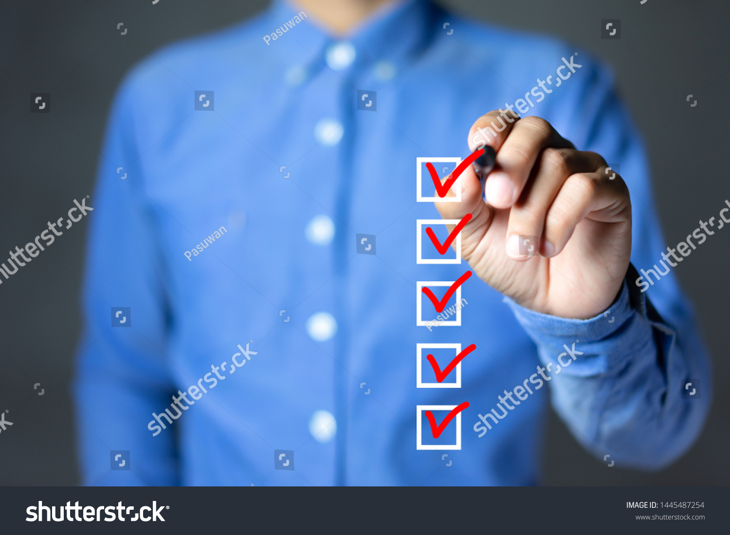 Checklist concept, Businessman checking mark on the check boxes with marker red #1445487254