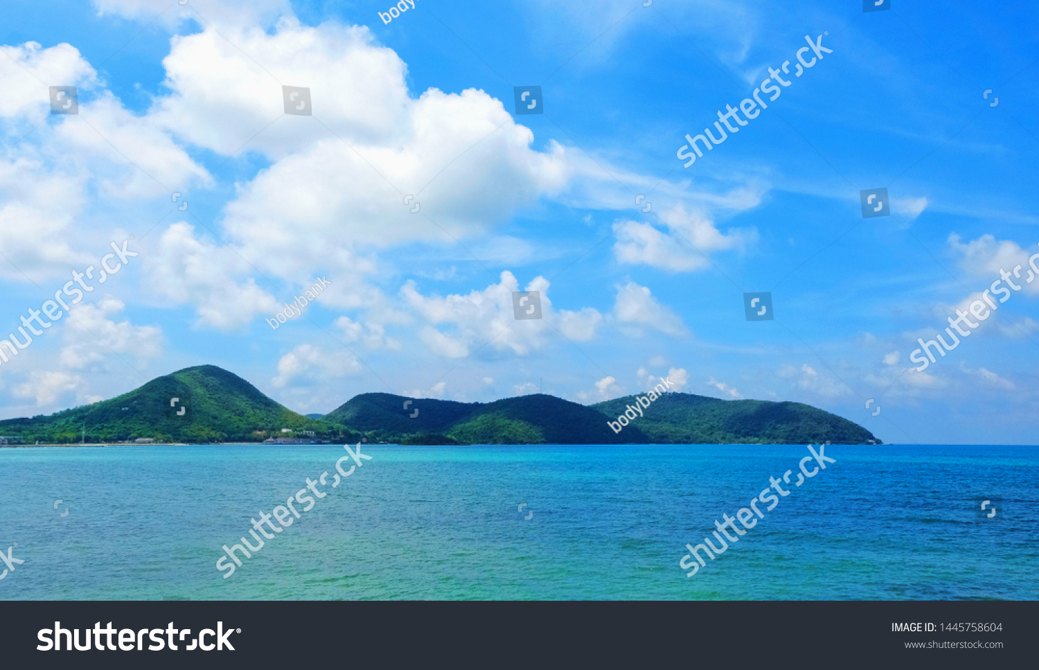 Sea and sky background. Sea view from tropical beach with sunny sky. Summer paradise beach of Thailand. Tropical shore. Tropical sea in Thailand. Exotic summer beach with clouds on horizon. Ocean beac #1445758604
