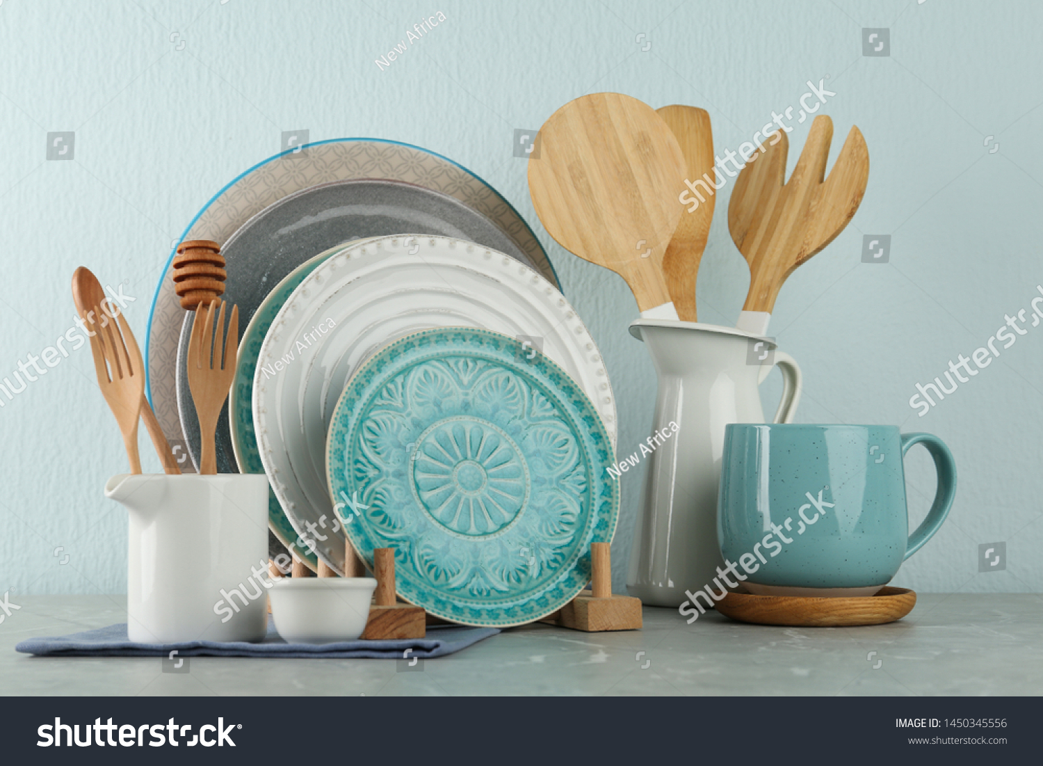 Set of kitchenware on grey marble table near light wall. Modern interior design #1450345556